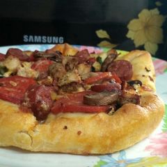 A picture of Chicken sausage barbecue pizza.