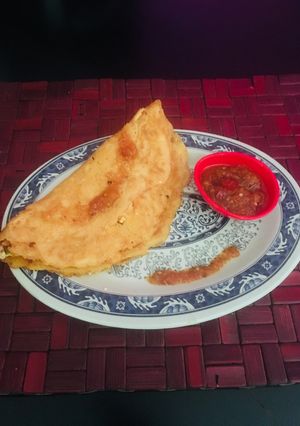 A picture of Moong Dal Chilla with Tomato chutney.