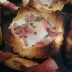 Bacon crust with baked egg ponds A picture of Bacon crust with baked egg ponds.