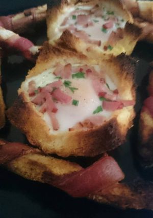 A picture of Bacon crust with baked egg ponds.