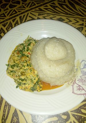 A picture of Eba and Egusi stew with minced Fish.