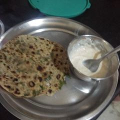 A picture of Palak prontha with curd.