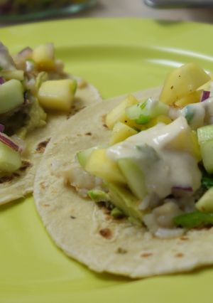 A picture of Fish tacos with mango salsa and yoghurt-lime sauce.