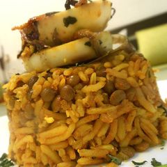 A picture of Masoor Pulao topped with Boiled Egg Slices.