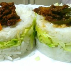 A picture of Goat meat strips in cabbage rice sandwich.