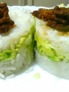 A picture of Goat meat strips in cabbage rice sandwich.
