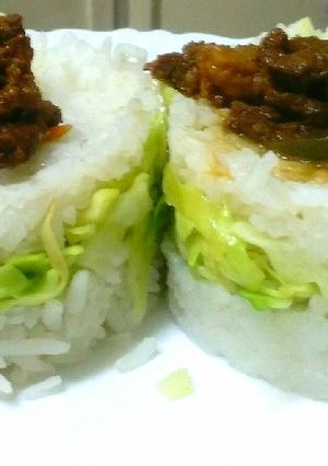 A picture of Goat meat strips in cabbage rice sandwich.