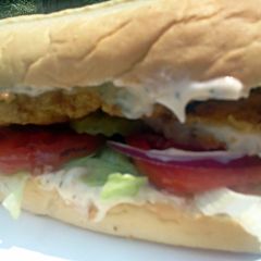 A picture of Super Fish Sandwich w/ dill sauce.