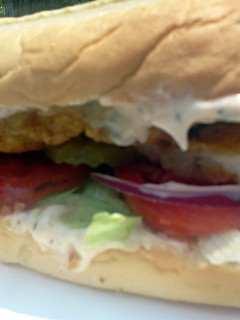 A picture of Super Fish Sandwich w/ dill sauce.
