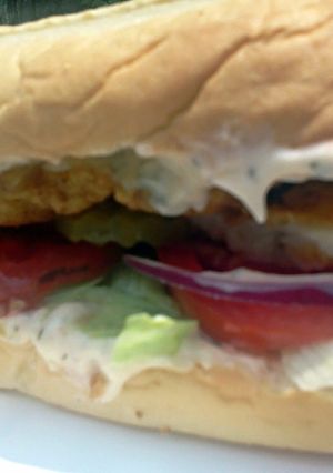 A picture of Super Fish Sandwich w/ dill sauce.