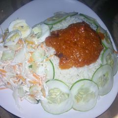 A picture of Rice and stew with coslow.