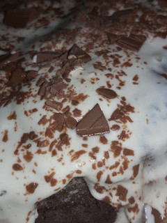 A picture of Chocolate cake with whipped cream.
