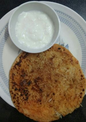 A picture of Rice paratha with curd.