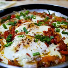 A picture of North African-Style Poached Eggs with Spiced Tomato Sauce.