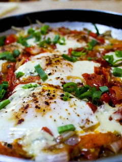 A picture of North African-Style Poached Eggs with Spiced Tomato Sauce.