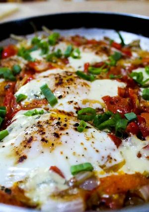 A picture of North African-Style Poached Eggs with Spiced Tomato Sauce.