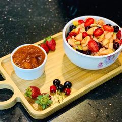 A picture of Fruit chaat with plum chutney.