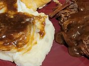 A picture of mashed potato with gravy