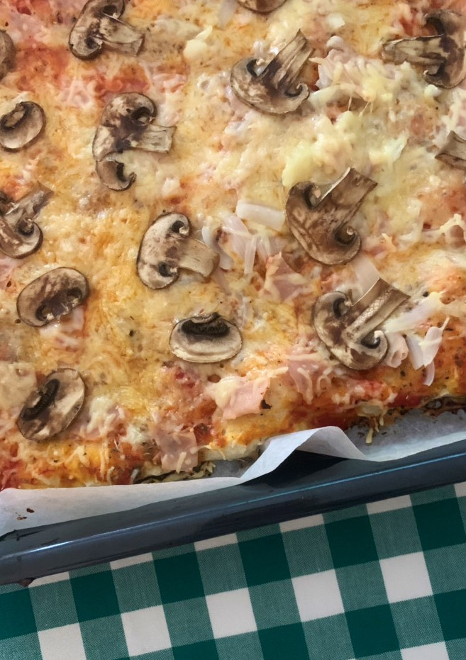 Una foto de Pizza de masa casera de jamón york y champiñones