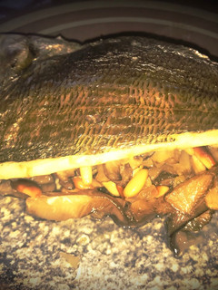 Una foto de Lomo de dorada al horno sobre cama de setas y piñones