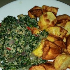 A picture of Fried sweet potatoes with scrambled veggie eggs.