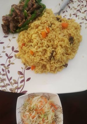 A picture of Curried rice, shredded beef and green pepper with coleslaw.