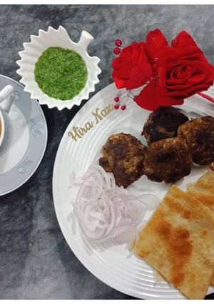 A picture of Kachay Qeemay ke kabab With Paratha, Green Chutney and Doodh-Patti Chai.