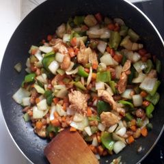 A picture of shrimps chicken breast vegetables sauce.