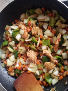 A picture of shrimps chicken breast vegetables sauce.