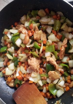 A picture of shrimps chicken breast vegetables sauce.