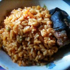 A picture of Coconut Jollof Rice and Fried Chevon.
