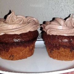 A picture of cookie brownie cupcakes w/chocolate marshmallow frosting.