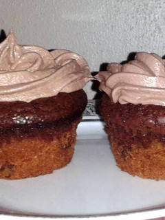A picture of cookie brownie cupcakes w/chocolate marshmallow frosting.