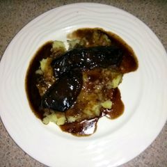 A picture of braised beef short ribs with garlic mashed potatoes.