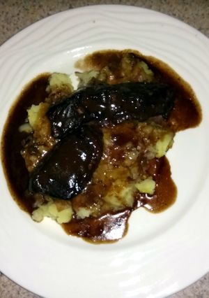 A picture of braised beef short ribs with garlic mashed potatoes.