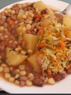 A picture of Githeri mixed with cabbage carrot and potatoes.