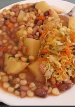 A picture of Githeri mixed with cabbage carrot and potatoes.
