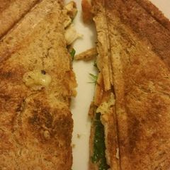 A picture of Cheesey chicken toastie wth spinach.