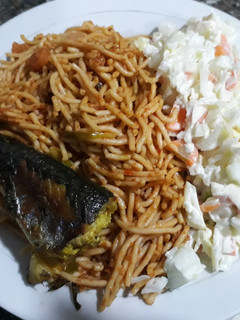 A picture of Spagetti with salad and fried fish.