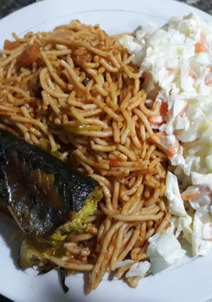 A picture of Spagetti with salad and fried fish.