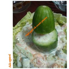 A picture of Veggies yogurt with cucumber garnishing.