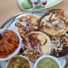 A picture of Onion Uttapam, Sambar, Chutney,.