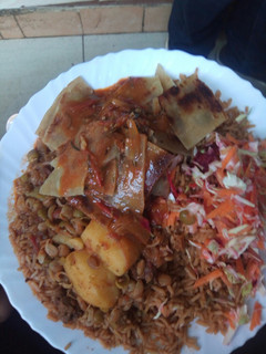 A picture of Pilau with chapo and beef.
