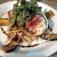 A picture of bacon wrapped stuffed chicken.