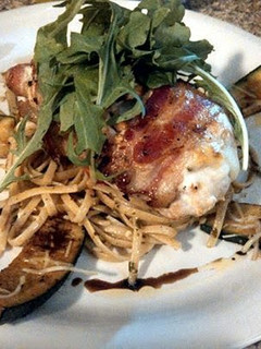 A picture of bacon wrapped stuffed chicken.