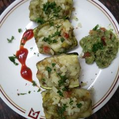 A picture of Zucchini stuffed with cheesy Guacamole.
