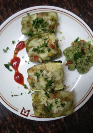 A picture of Zucchini stuffed with cheesy Guacamole.