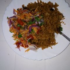A picture of Beef pilau and kachumbari.