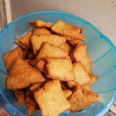 A picture of Crunchy soft Mandazi with cinammon and orange rind.