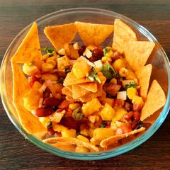 A picture of Mango salsa dip with nachos.